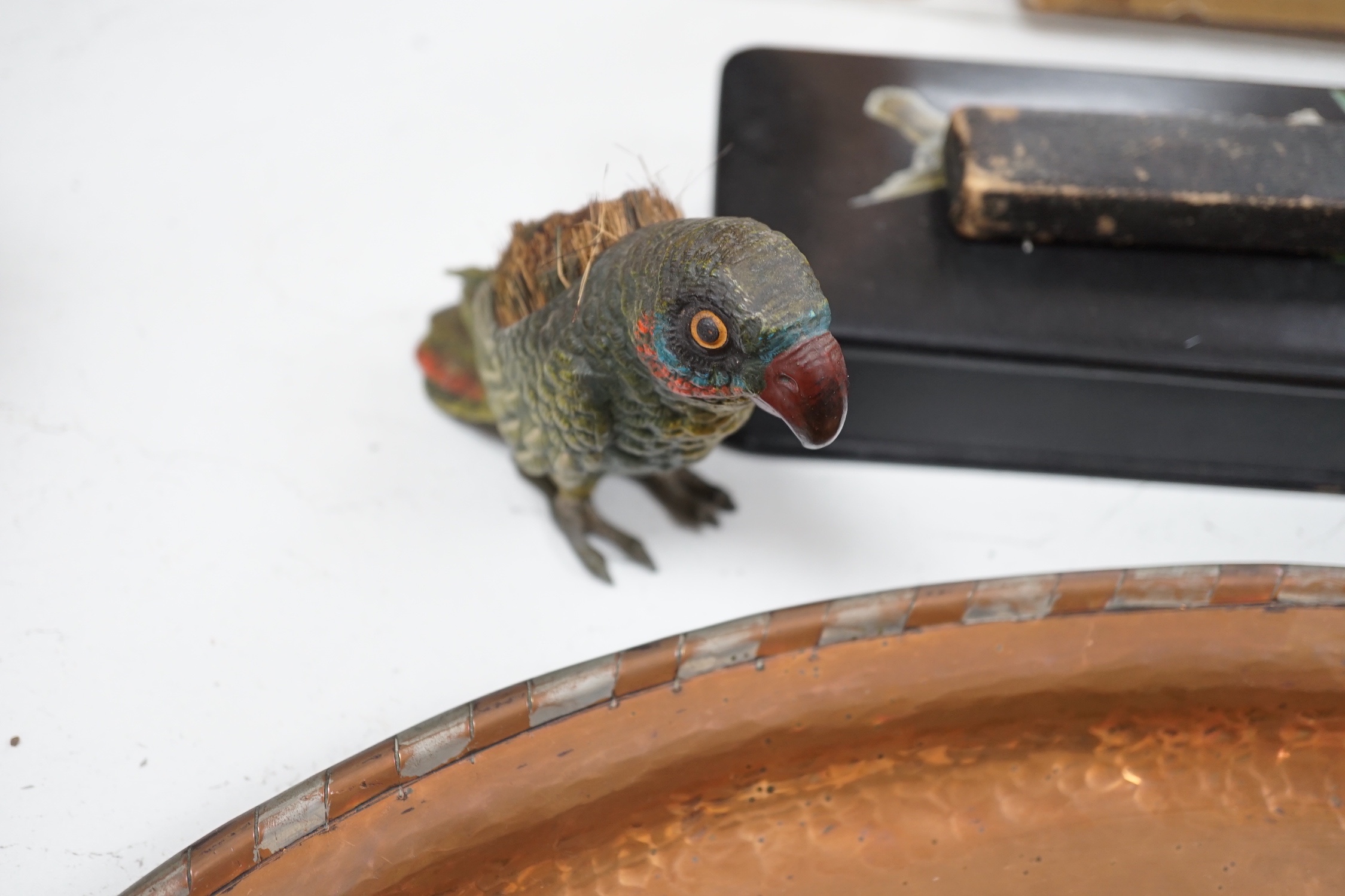 A large oval copper tray, cold-painted spelter parrot and four other items